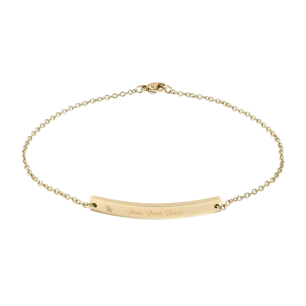 Gold bracelet with engraved message on a white background